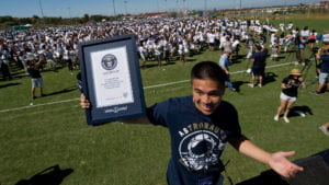 Student holding world record display
