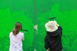 Students painting over Graffiti