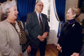 Rowland with wife Joan laughing with Hillary Clinton