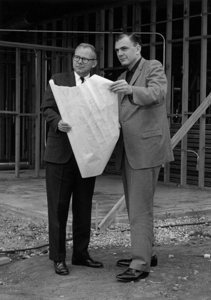 Rowland reviewing building plans with Ivan Hinderaker