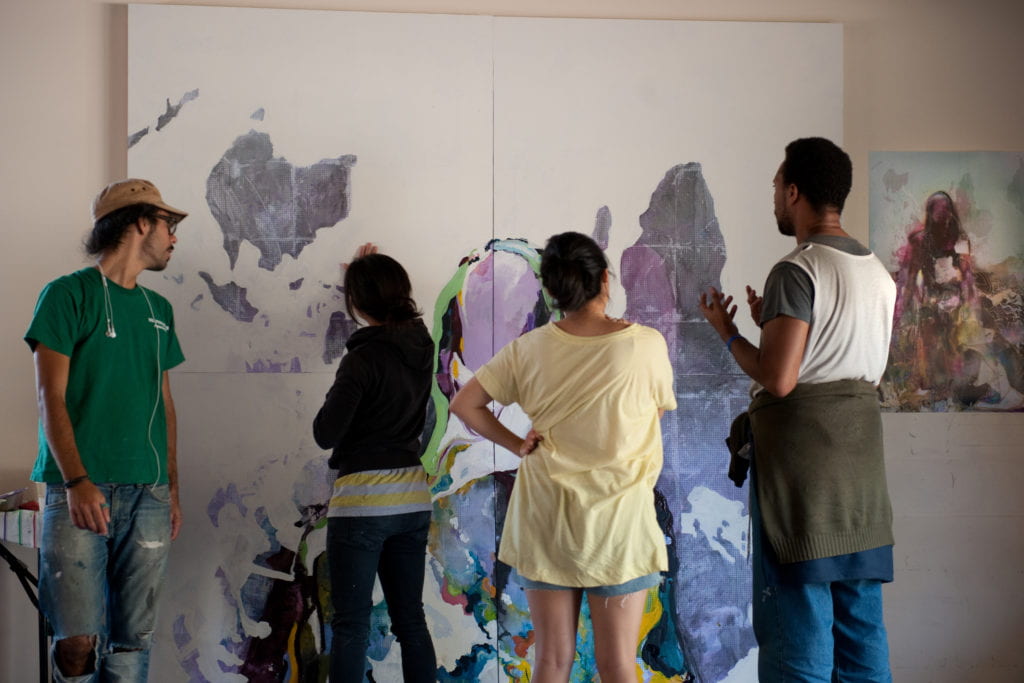 Mural contributors discuss the upside down and inverted world map.