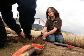 Little Luiseno Ricky Galvin lends a hand to UCI students planting a garden