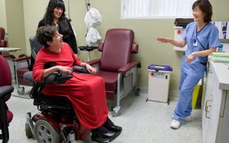 MS patient Shirley Cero jokes with nurse Monica Shim and her caregiver Elsa Palomino