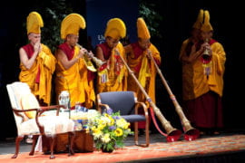 Buddhist monks play traditional Tibetan horns