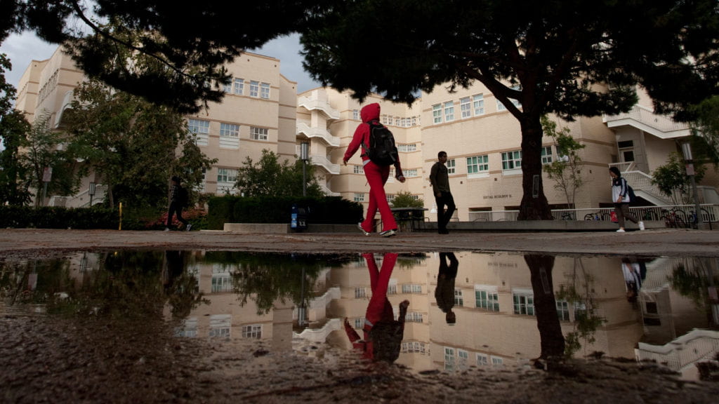 A student walks past the School of Social Sciences