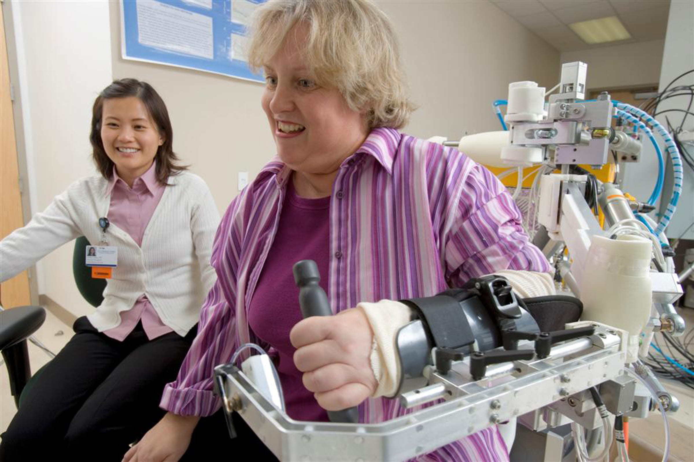 Patient using the robotic arm for rehab