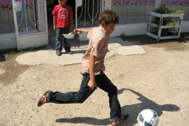 A boy kicking a soccer ball