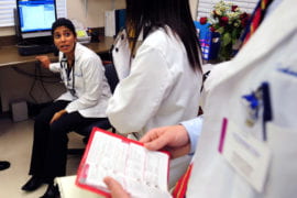 Charitha Reddy and other medical students consult about patient treatment
