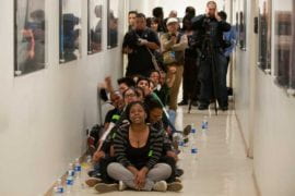 Students and labor organizers chant in a hallway of the UC Irvine administration building