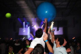Students propel giant inflated balls during the concert.