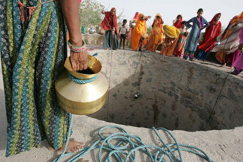 Women draw water from a well near Dudu, Rajasthan