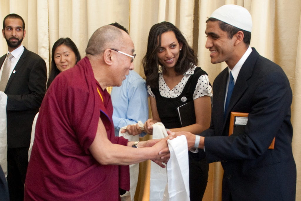 The Dalai Lama presents a white silk scarf to Dalai Lama Scholar Armaan Rowther