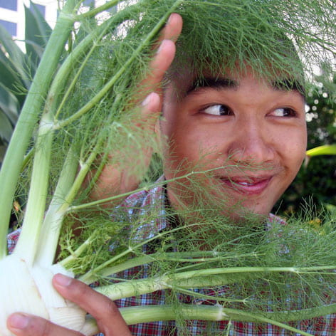 Hai Vo peeks through fennel he purchased at the Irvine farmers market