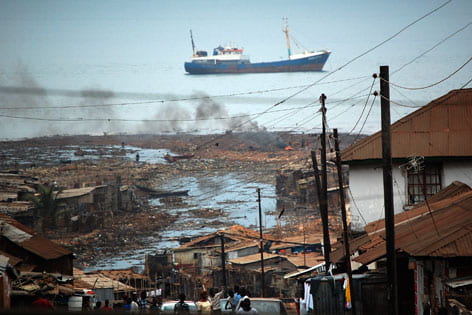 A boat sails through the port of Freetown, Sierra Leone