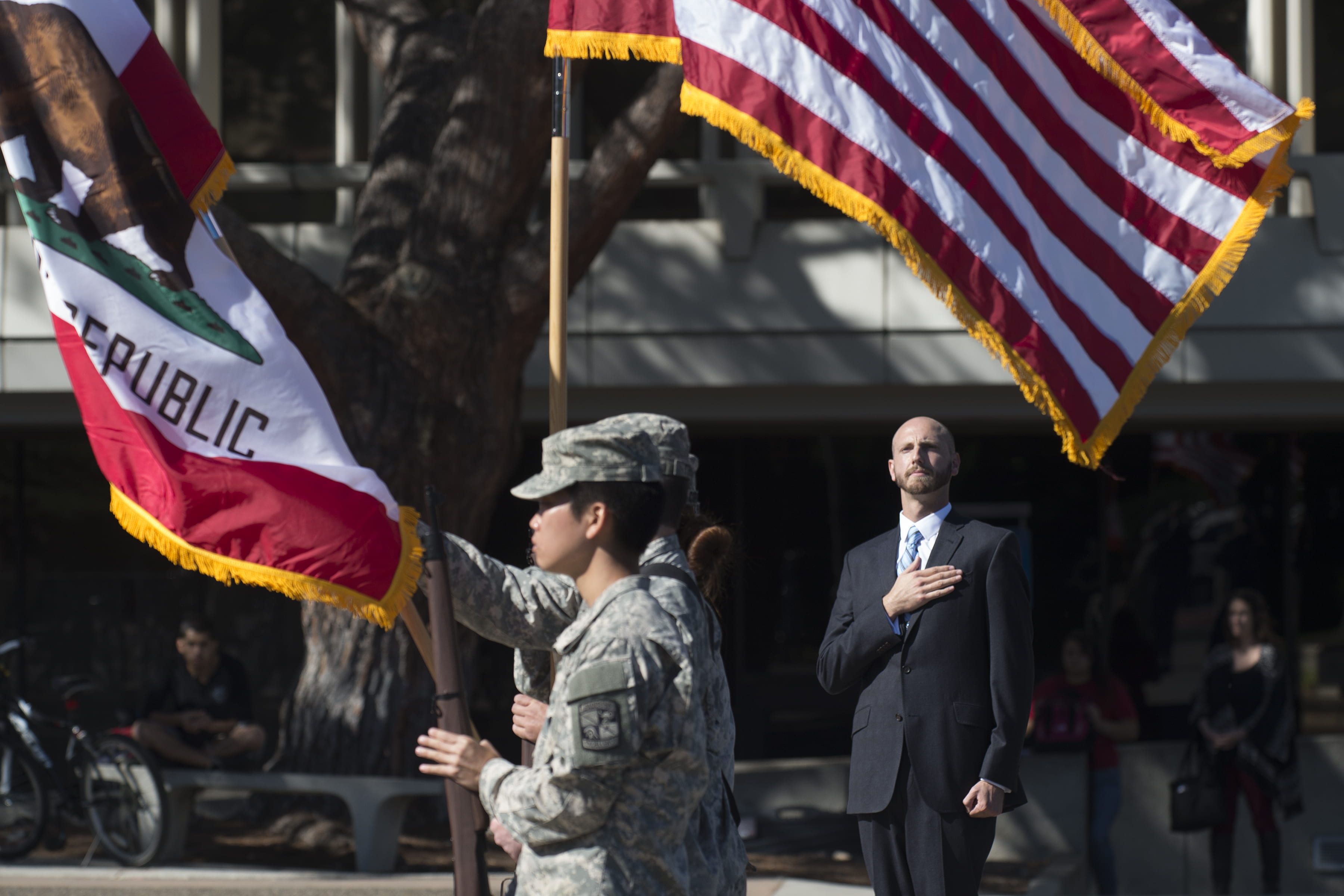 U.S. Navy vet Harwood Garland, a UCI veteran suicide researcher and an inaugural instructor in the campus’s new veterans studies program, salutes a color guard in front of Aldrich Hall during a past Veterans Day ceremony.