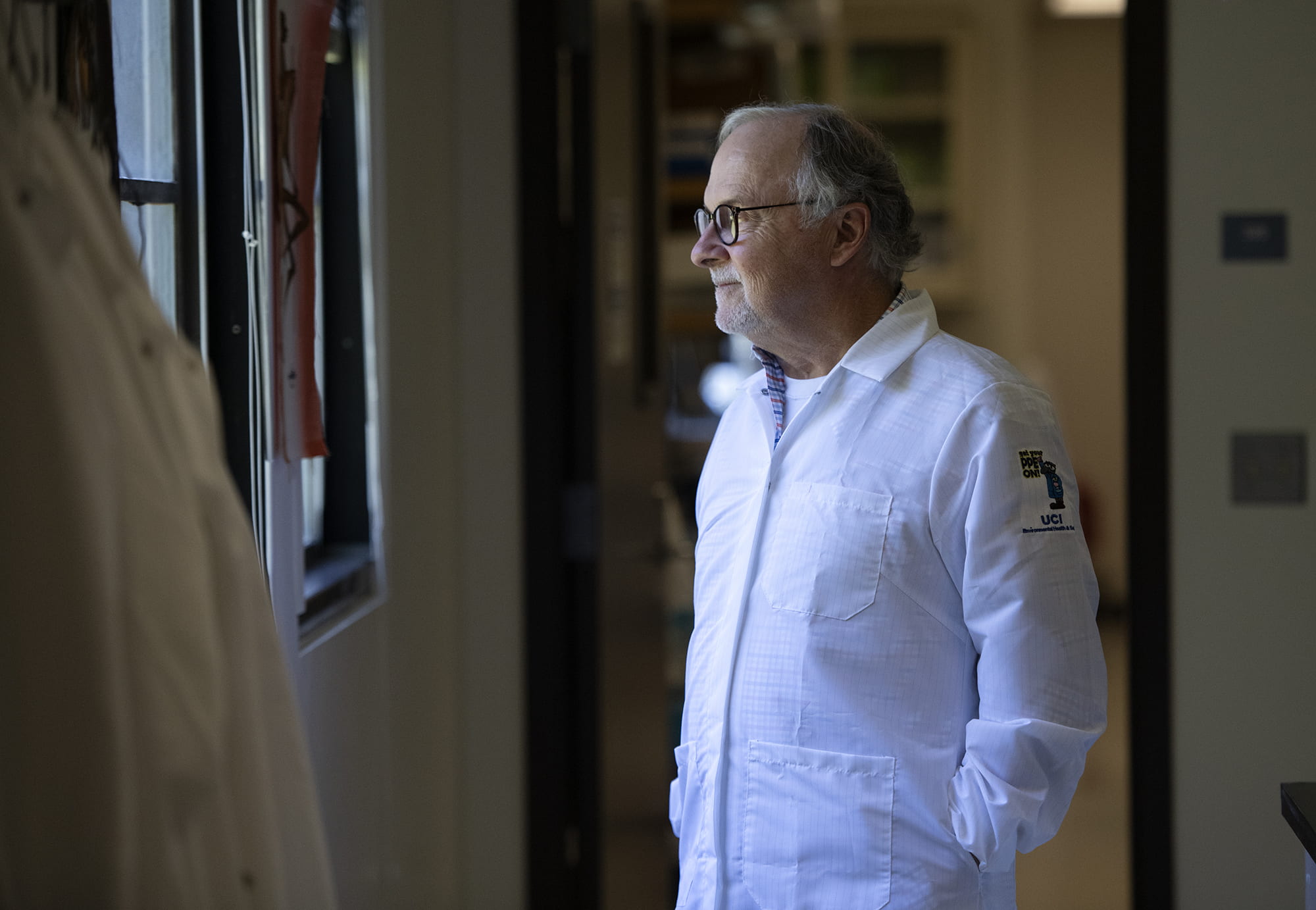 Phil Felgner, director of UCI’s Vaccine R&D Center, gazing through a window