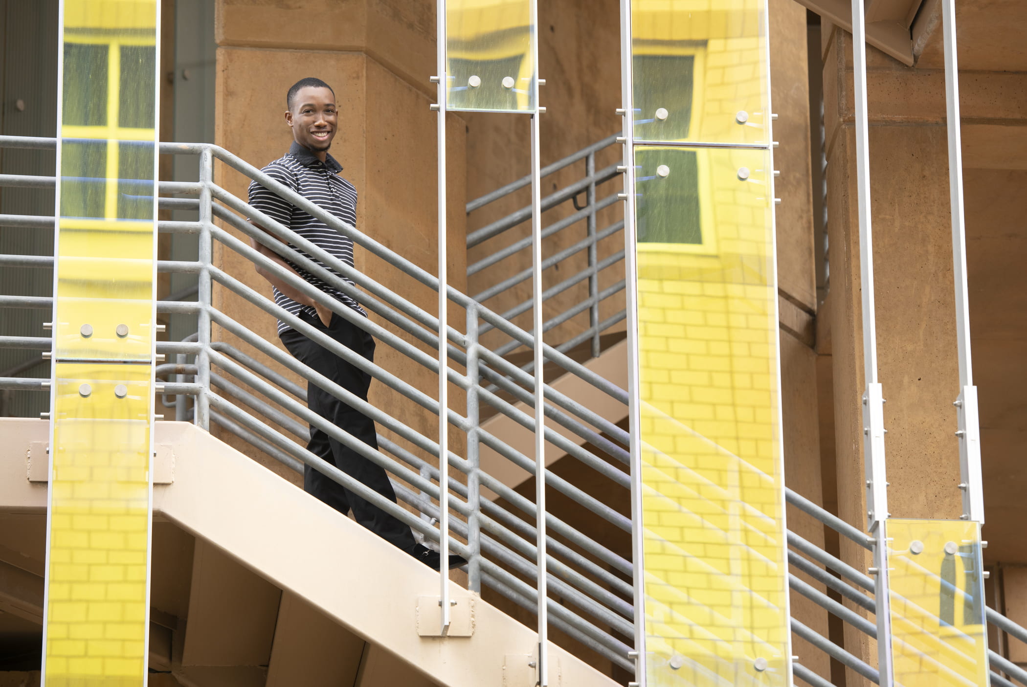 David Sanusi, international studies major, standing on stairs.