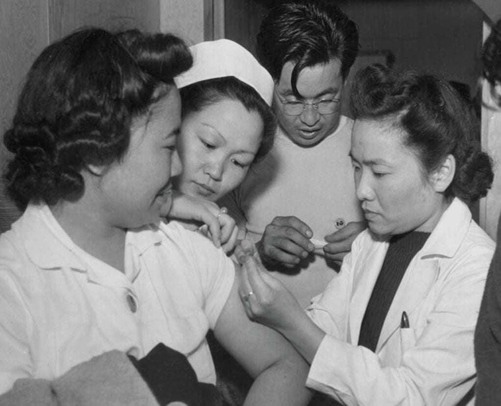 In this July 1942 U.S. Office of War Information photo from the International Mission Photography Archive, newly arrived Japanese Americans are vaccinated at the Santa Anita Park internment camp in Arcadia. 