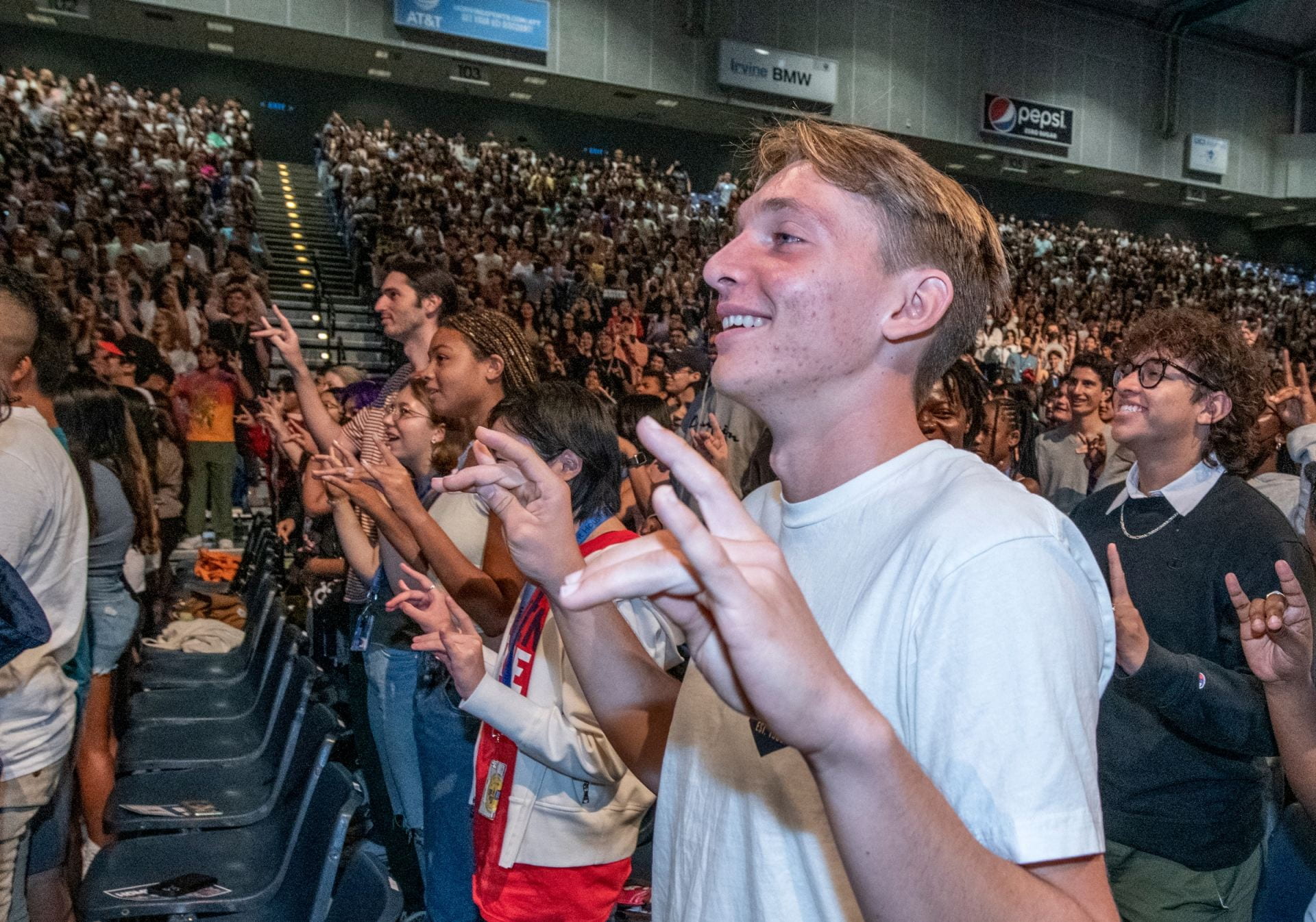 New Anteaters flash the Zot sign at the New Student Convocation at the Bren Events Center.