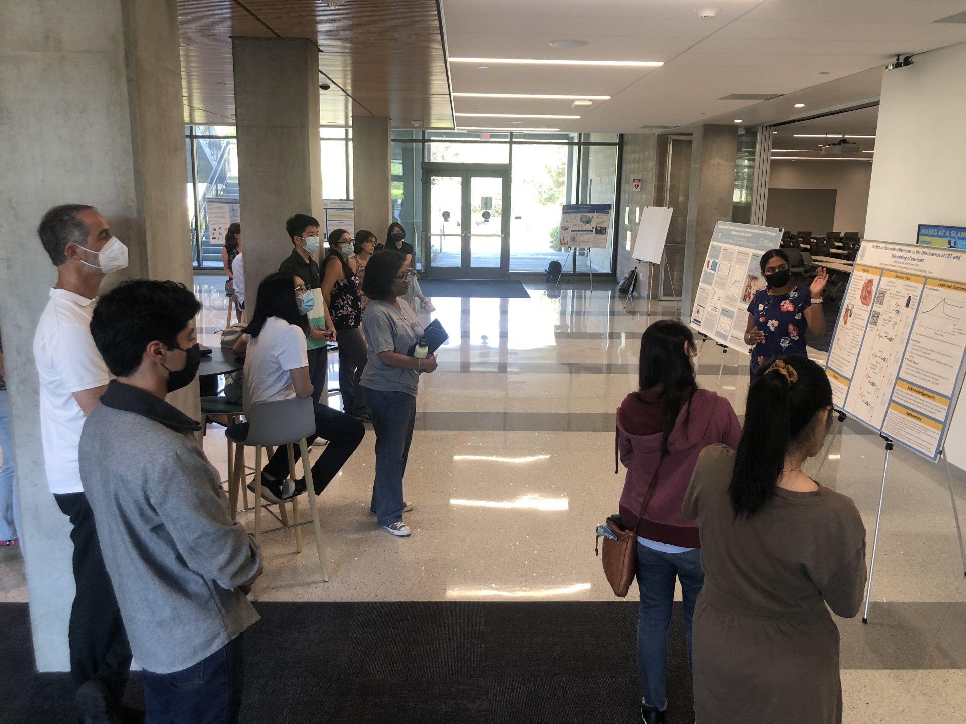 Undergraduate students in the Samueli Interdisciplinary Research in Pods program gather in the lobby of UCI’s Interdisciplinary Science and Engineering Building for a poster session to discuss their summer research projects.