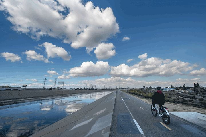 A cyclist zooms along the bike path along the LA river in North Long Beach. 