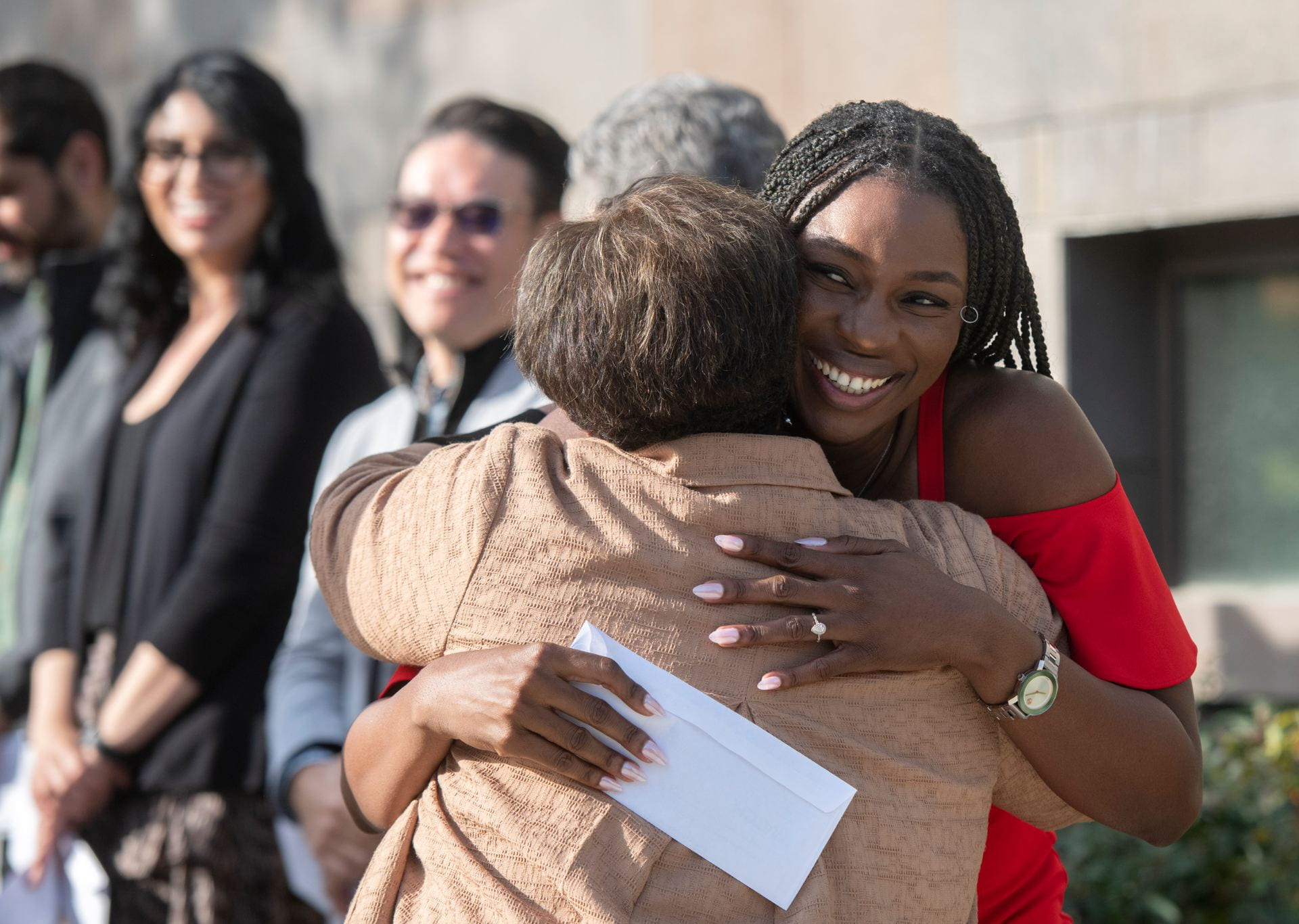 Ify Okwuosa (right) gets a congratulatory hug from Dr. Carol Major at Friday’s Match Day ceremony. She’ll be going into internal medicine at UCLA.