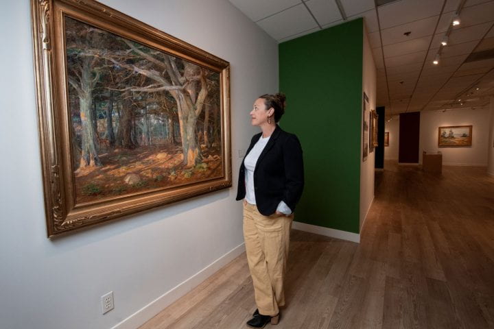 Cassandra Coblentz, guest curator of Langson IMCA’s upcoming exhibition “Indefinitely Wild: Preserving California’s Natural Resources,” admires Detlef Sammann’s 1915 “Del Monte Forest.”
