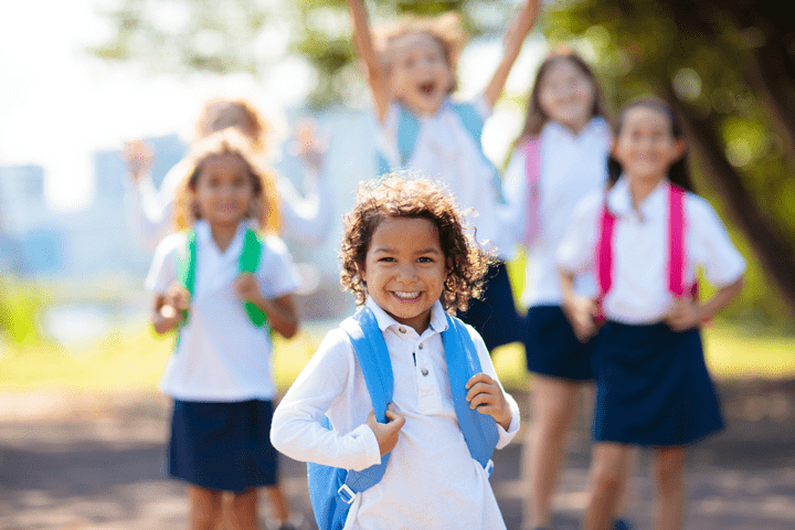 Children in school uniforms smiling