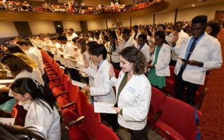 UCI School of Medicine holds its White Coat Ceremony, where first year med students receive their traditional white coats, at Chapman University.