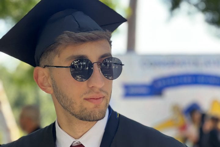 Derenik Dumanyan wearing a graduation cap and sunglasses.