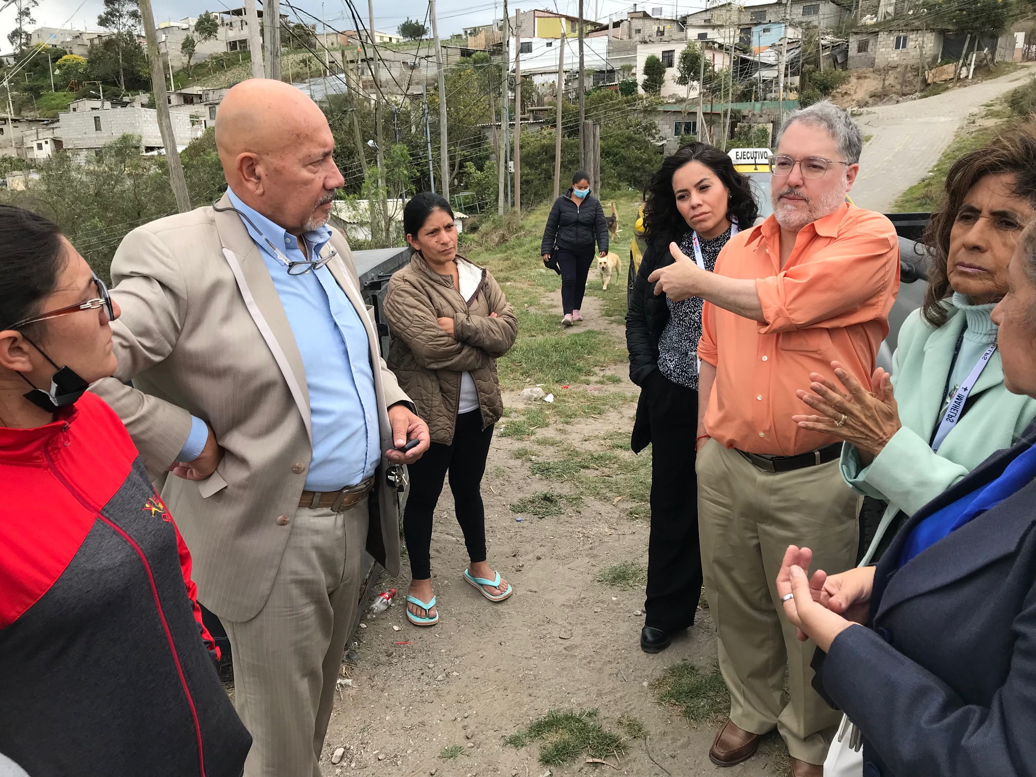 In advance of their 2023 humanitarian mission, UCI Health’s Dr. Cristobal Barrios Jr. (in orange shirt) and IMAHelps co-founder Ines Allen (in aqua jacket) meet in Ecuador with another nonprofit leader, Roberto Altamirano (in blue shirt), and community members.