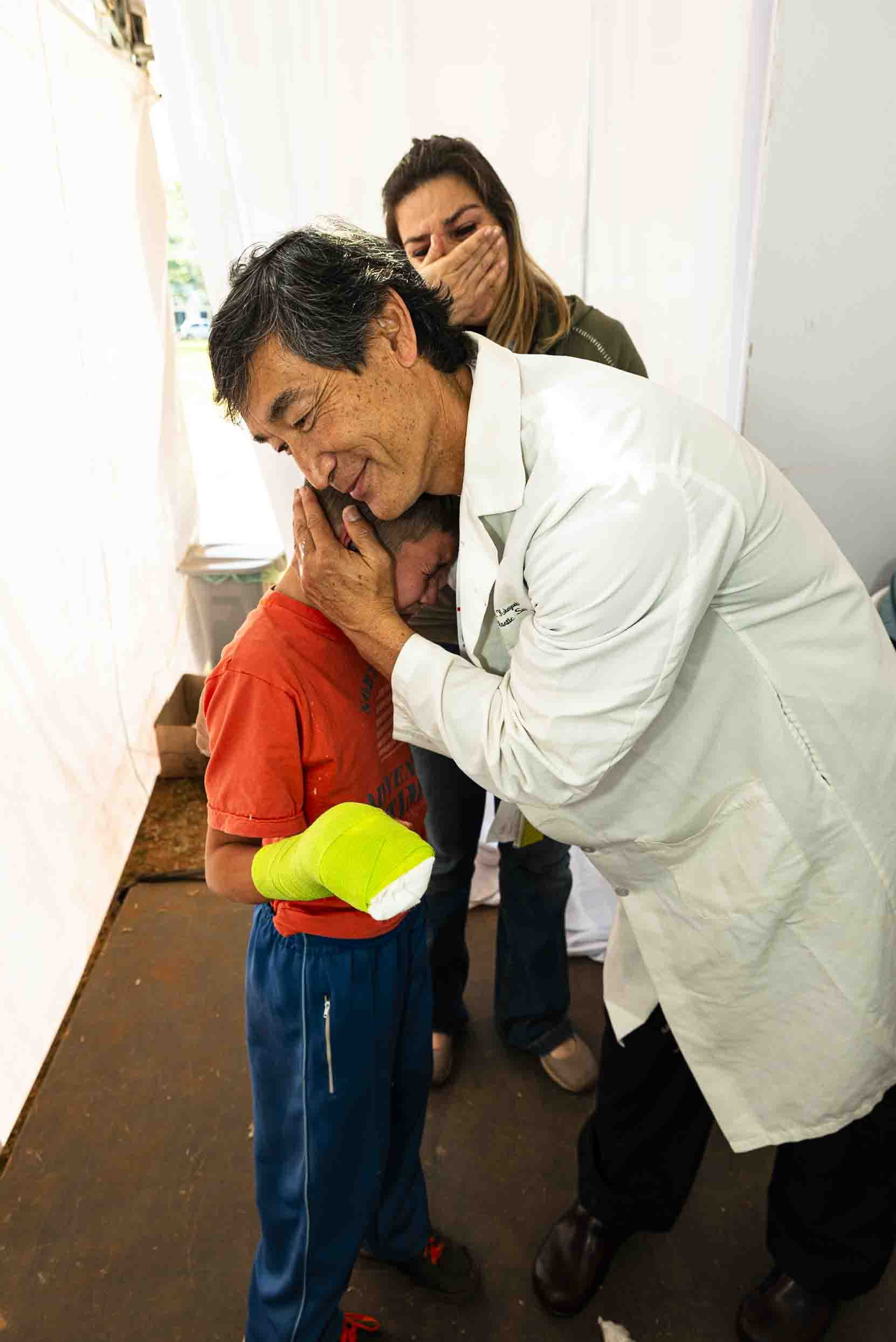 A 10-year-old boy whose parents abandoned him because of a deformed right hand tearfully thanks Dr. Mark Kobayashi, the UCI Health plastic surgeon who corrected the defect during a 2018 IMAHelps visit to Paraguay.