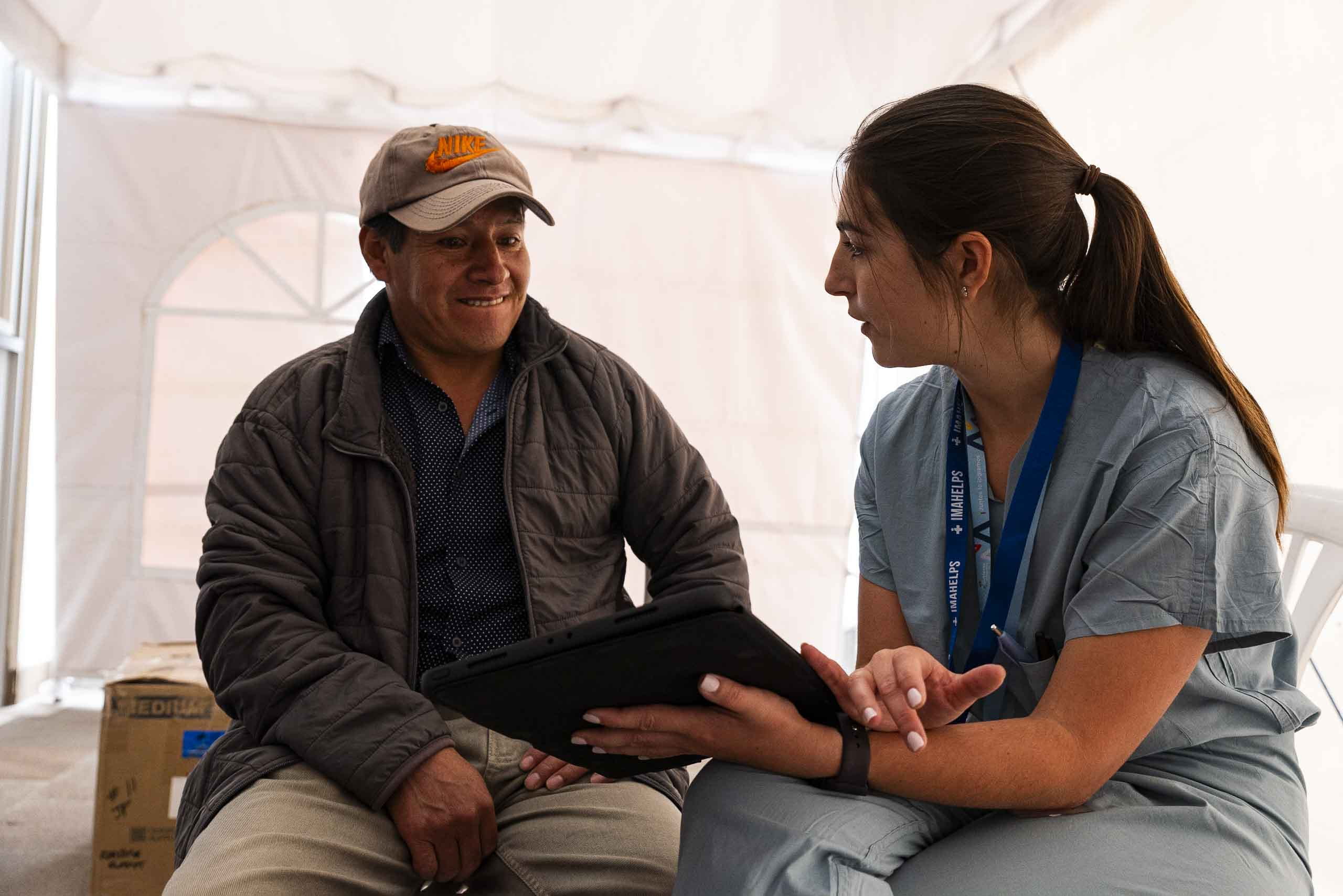 UCI medical student Naomie Devico Marciano talks with a patient during a humanitarian mission to Quito, Ecuador.