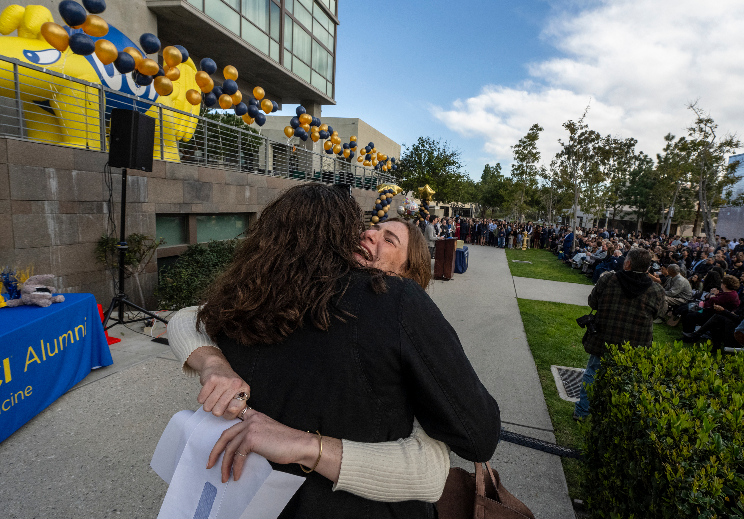 Serena Tally, being hugged by a woman, is exultant that she’ll be going to UC San Diego for a residency in emergency medicine.