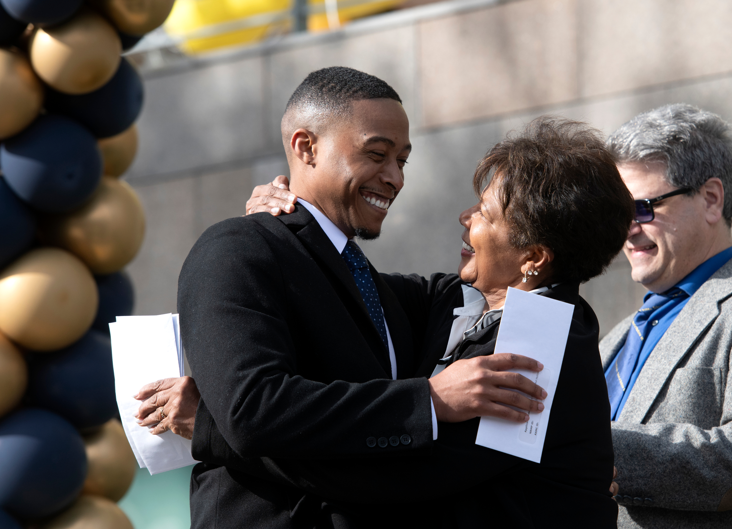 Aeryus Holloway gets a congratulatory hug from UCI’s Dr. Carol Major after he learning that he’ll be going to the University of Arizona College of Medicine – Phoenix for a residency in orthopedic surgery.