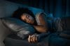 Beautiful african american woman sleeping in her bed at night