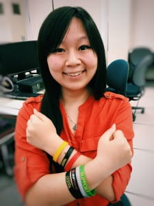 Recent computer game science grad Kathy Chiang, who helped shape the UCI eSports initiative, shows off her rubber gaming bracelets. Tonya Becerra / UCI