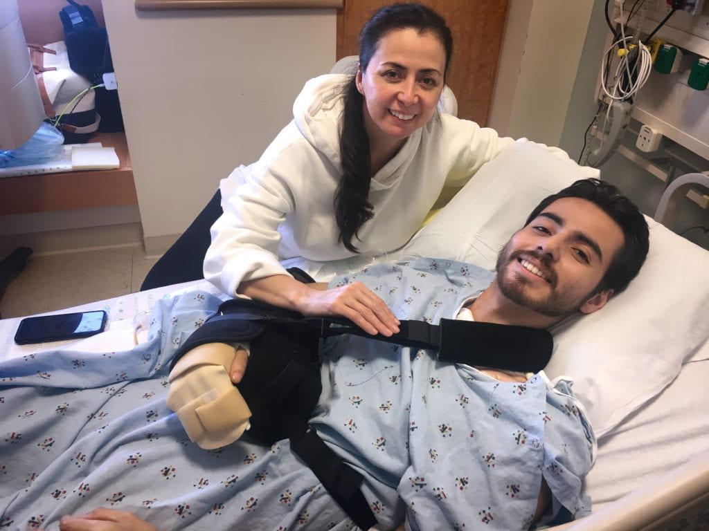 Christian Lopez (in hospital bed) and his mother, Sandra, are all smiles on the day of his discharge from UCI Medical Center.